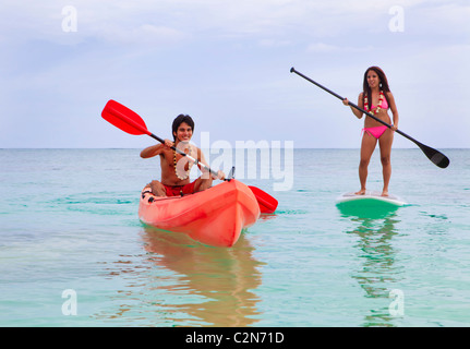 asian couple with kayak and paddle board in hawaii Stock Photo