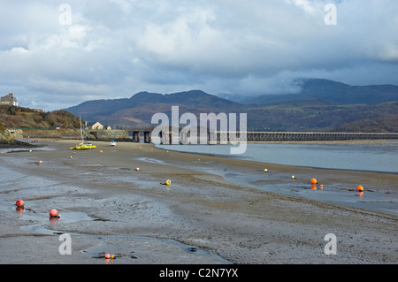 Barmouth Railway Bridge line over the Mawddach Estuary at low tide in winter  Gwynedd mid Wales UK United Kingdom GB Great Britain Stock Photo