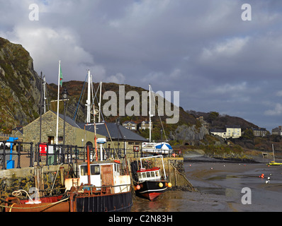 Fishing boats boat at low tide in winter Barmouth Harbour Gwynedd mid Wales UK United Kingdom GB Great Britain Stock Photo