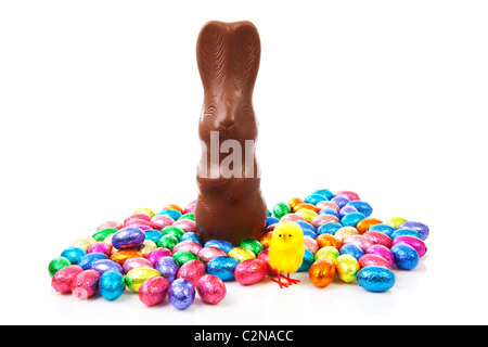 Milk chocolate easter bunny and colorful eggs over white background Stock Photo