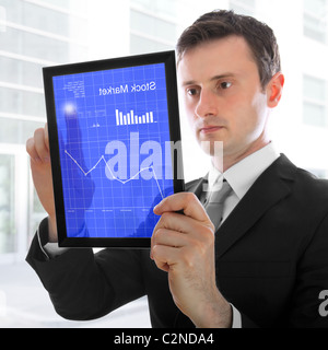 Businessman holding a touchpad pc, one finger touches the screen and checking the stock market, isolated on white Stock Photo