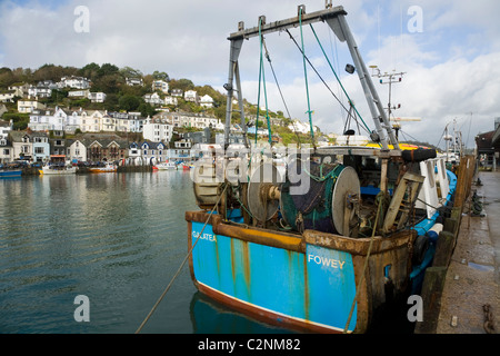 Cornish fishing boat with fishing net / nets and gear, moored at the quay / quayside in the harbour at Looe in Cornwall. UK. Stock Photo