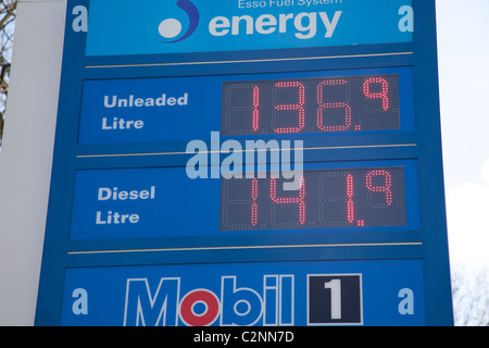Petrol prices on illuminated Esso sign board Stock Photo