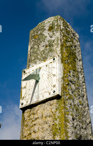 Sundial on a sunny day with blue sky and shadow: near to the entrance to Looe harbour in Cornwall. UK. Stock Photo