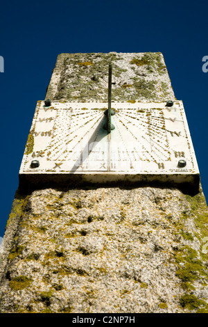 Sundial on a sunny day with blue sky and shadow: near to the entrance to Looe harbour in Cornwall. UK. Stock Photo