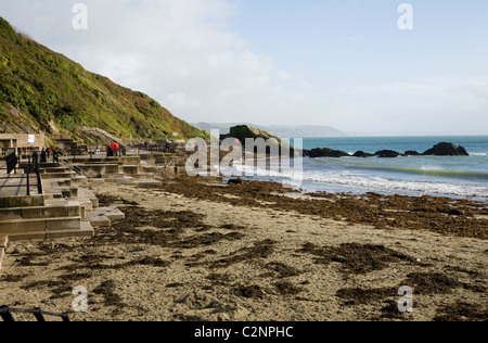 The Cornish sandy beach east of the harbour entrance of Looe in Cornwall. UK. Stock Photo