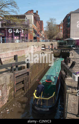 Canal boat going entering lock on the Rochdale canal in the Village district of central Manchester. Stock Photo