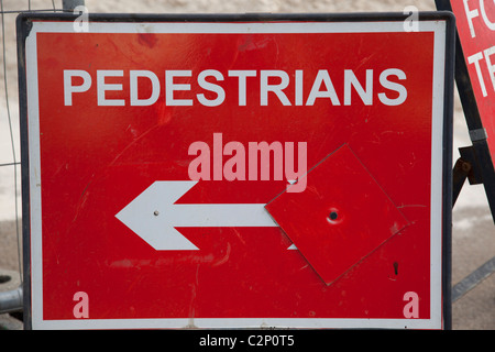 Red sign with white writing and arrow Stock Photo