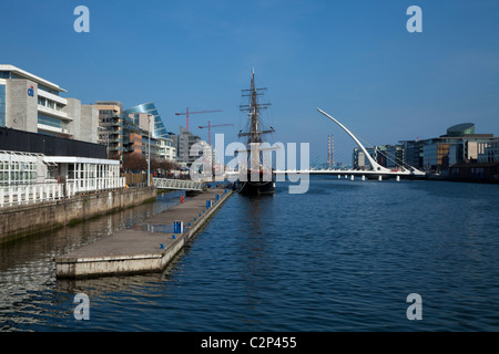The Samuel Beckett Bridge, Designed by Caltrava, And 'Jeanie Johnston'  Famine Ship and Museum, River Liffey, Dublin City, Ireland Stock Photo