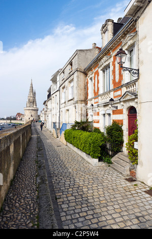 View along the city walls on the harbourfront looking towards the Tour de la Lanterne, La Rochelle, Poitou Charentes, France Stock Photo
