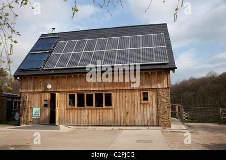 Solar thermal and PV panels on roof of sustainable oak timber building Ruskin Studio Wyre Forest Bewdley UK Stock Photo