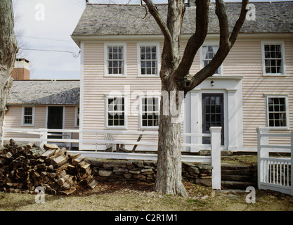 Late 18th -early 19thc timber frame clapboard farmhouse in winter, logpile of firewood, Lyme, Connecticut Stock Photo