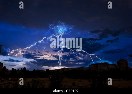 Lightning and storm clouds over the city evening Stock Photo
