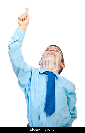 Young boy pointing up to copy space and smiling isolated on white background Stock Photo