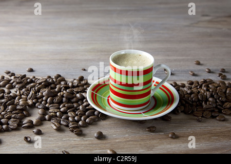 Coffee in striped cup with beans Stock Photo