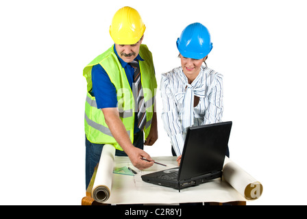 Cheerful two architects in office working on projects and laptop and the man showing her colleague woman Stock Photo