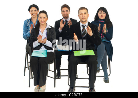 Five business people sitting on chairs at conference and applauding isolated on white background Stock Photo