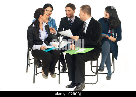 Happy team of five business people sitting on chairs and having funny conversation at seminar isolated on white background Stock Photo