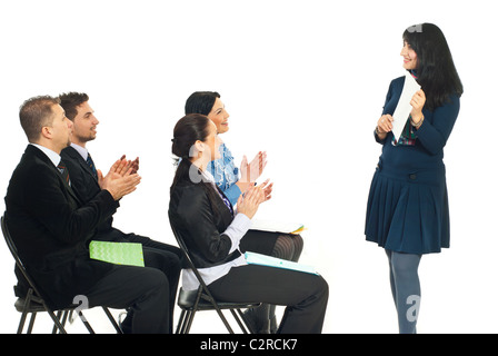Business woman showing her successful work paper and her colleagues congratulate by applause in a training classroom Stock Photo