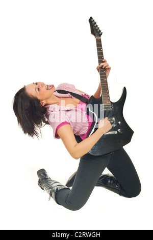 Rock girl standing on her knees playing electronic guitar and singing isolated on white background Stock Photo