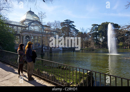 Visitors and tourists admire the Palacio de Cristal, Crystal Palace, Parque del Retiro, Retiro Park, Madrid, Spain, Europe, EU Stock Photo