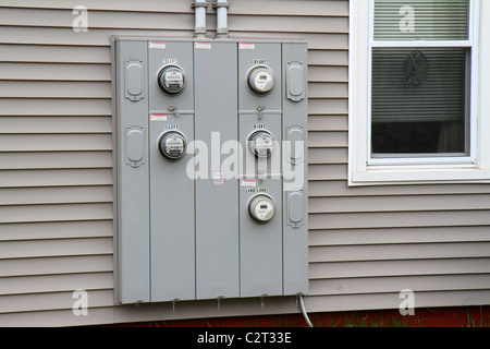 Electric meters on exterior wall of apartment building Stock Photo