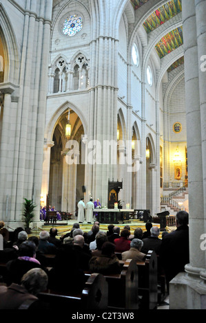 Mass observance in the large cathedral of Madrid, Spain: Catedral De Nuestra Senora De La Almudenaa Stock Photo