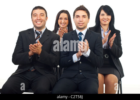 Successful happy business people sitting on chairs and clapping at conference Stock Photo