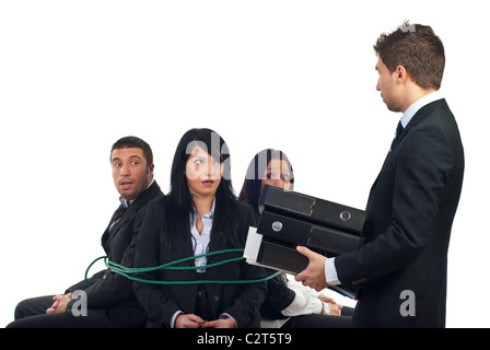 Chief bring more folders to his shocked employees tied in chairs and force them to work overtime Stock Photo