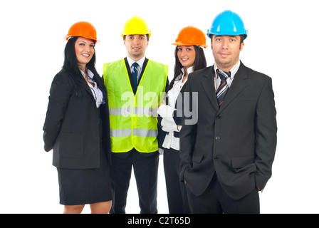 Architect man standing with hands in suit pockets and his teamwork smiling in background Stock Photo