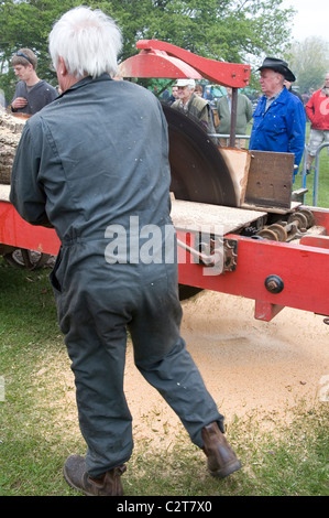 Men demonstrating the Cutting of wood with Tractor driven Rack Saw   Old Working Farm Machinery Stock Photo