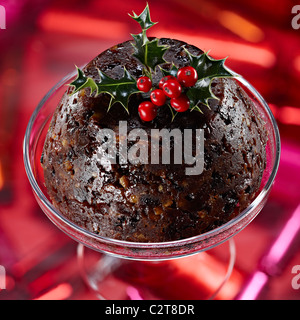 Christmas pudding with holly leaves berries Stock Photo