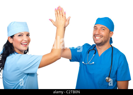 Successful team of surgeons giving high five and laughing isolated on white background Stock Photo