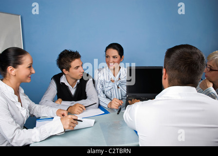 Group of business people using a laptop during a meeting,they having fun and discussion together Stock Photo