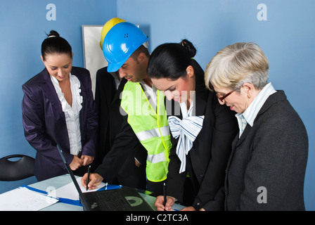 Cheerful architects and engineers having a business meeting in office and they writing and planning together Stock Photo