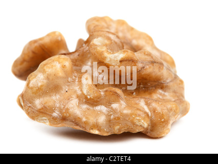 half peeled walnut closeup isolated on white background Stock Photo