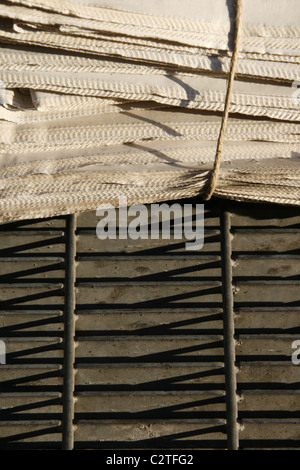 pile of old used newspapers left in street road in city town Stock Photo