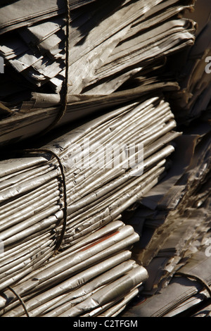 pile of old used newspapers left in street road in city town Stock Photo