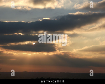 sun shine through cloudy sky Stock Photo