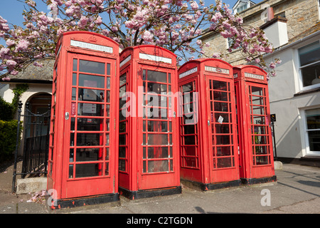 Row of 4 red British phone boxes in Truro, Cornwall UK. Stock Photo