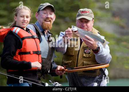 Family & Guide showing off Rainbow Trout caught from drift boat Kenai River Kenai Peninsula Alaska Stock Photo