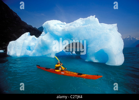 Sea Kayaker Approaches Iceberg Tracy Arm SE AK Summer Fords-Terror Wilderness Area Stock Photo