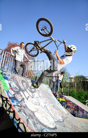 BMX biker performing tricks on a ramp Stock Photo