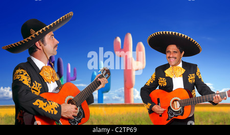 Mexican mariachis charro singing playing guitar in cactus background Mexico Stock Photo