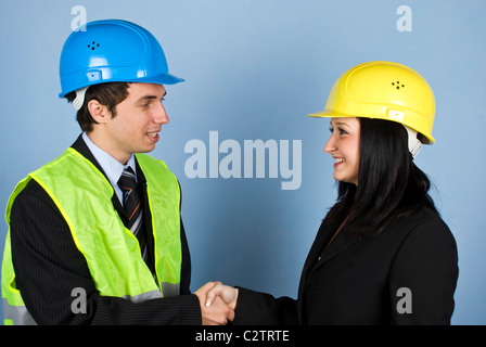 Two architects man and woman having a conversation and shaking their hands Stock Photo