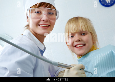 Portrait of female dentist and little girl looking at camera Stock Photo