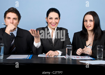 Businesswoman in the middle are expressing her vision and talk about strategy at the conference and two other businesspeople Stock Photo