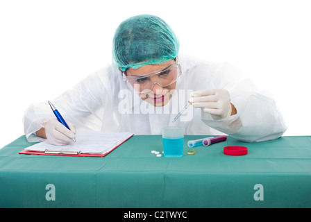 Scientist woman pouring with pipette making experiments and taking notes in her clipboard Stock Photo