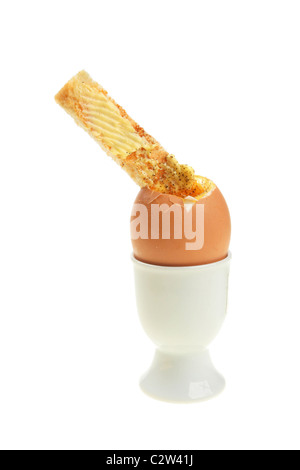 Boiled egg and buttered toast soldier in an egg cup Stock Photo