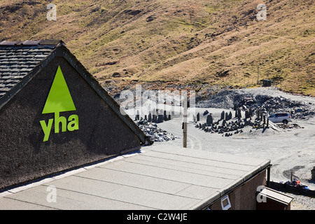 YHA sign on Youth Hostel by slate mine at top of the pass in Lake District National Park. Honister Pass, Cumbria, England, UK, Britain Stock Photo